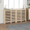 A wooden radiator cover is placed in front of a window, with a rug in the foreground. Podgląd zdjęcia produktu