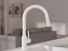 A white kitchen faucet is shown in a modern kitchen setting. Produktbild-Vorschau