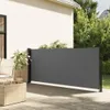 A retractable side awning is set up on a wooden deck next to a house, providing privacy and shade. Voir les images du produit
