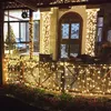 A balcony decorated with fairy lights and a Christmas tree visible inside. Náhľad obrázku produktu