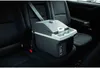 A portable cooler is secured with a seatbelt in the back seat of a car. Podgląd zdjęcia produktu