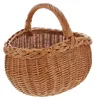 A woven wicker basket with a braided rim and a curved handle, presented against a white background. Produktbild-Vorschau