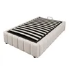 A white upholstered bed frame with a slatted mattress base, viewed from a slight diagonal angle. Náhľad obrázku produktu