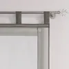 A close-up view of a gray sheer curtain with fabric loops hanging from a metal curtain rod. Produktbild-Vorschau