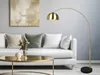 A modern living room with a white sofa, a coffee table, and a floor lamp. Anteprima dell’immagine prodotto