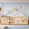A child's bed with a house-shaped frame, decorated with stuffed animals and books. Voir les images du produit