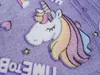 A close-up of a purple blanket with a unicorn design and text. Náhled obrázku produktu