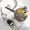A hand is cleaning a multi-mold frying pan in a kitchen sink. Anteprima dell’immagine prodotto