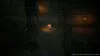 A character in a video game is walking down a dark, stone corridor. Produktbild-Vorschau
