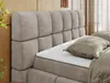 Close-up of a bed with a textured headboard and mattress. Produktbild-Vorschau