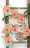 A collection of handmade reindeer-themed advent calendar bags hanging on a wooden ladder, decorated with pine branches. Produktbild-Vorschau