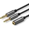 A close-up shot of a Ugreen audio splitter cable with gold-plated connectors and a silver housing. Podgląd zdjęcia produktu