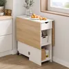 A compact kitchen table with a drop-leaf extension, a drawer, and shelving, shown in a kitchen setting. Voir les images du produit