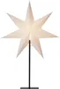 A white star-shaped lamp on a black stand against a white background. Podgląd zdjęcia produktu