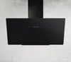 A black range hood mounted on a textured wall. Produktbild-Vorschau