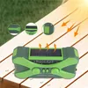 A green emergency radio is placed on a wooden surface, with sunlight and arrows indicating solar charging. Produktbild-Vorschau