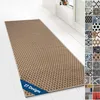 A long runner rug with a geometric pattern is laid out on a white wooden floor in a hallway. Podgląd zdjęcia produktu