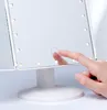 A hand is touching a makeup mirror with LED lights. Produktbild-Vorschau