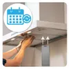 A person is shown installing a metal grease filter into a range hood. An overlay graphic shows a calendar icon with "3x" and a circular arrow, suggesting a maintenance schedule. Produktbild-Vorschau