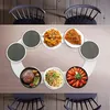 A dining table with chairs and a rotating serving tray holding various dishes. Anteprima dell’immagine prodotto