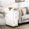A white folding table with drawers and cabinets is placed next to a gray sofa in a living room. Produktbild-Vorschau