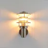 A wall-mounted outdoor light fixture with a metallic finish and glass panels. Produktbild-Vorschau