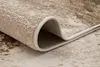 A close-up view of a rolled-up rug, showing the texture and edge. Produktbild-Vorschau