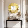 A gold decorative wall clock with Roman numerals is displayed above a black console table in a well-lit hallway. Voir les images du produit