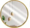 A round mirror with a golden wooden frame reflects a room with hanging pendant lights and a plant. Náhled obrázku produktu