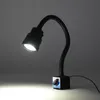 A black LED machine lamp with a flexible gooseneck and a magnetic base is illuminated against a dark gray background. Produktbild-Vorschau
