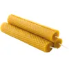 Three rolled beeswax candles with wicks are stacked diagonally against a white background. Náhled obrázku produktu