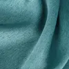 A close-up view of a teal-colored fabric, showing its texture and weave. Voir les images du produit