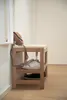 A shoe bench with a bag and shoes on it, placed near a wall. Náhled obrázku produktu