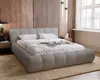 A modern bedroom with a plush grey bed. Náhled obrázku produktu