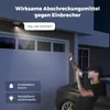 A security camera is mounted on a garage, with a person attempting to break in. The camera is shown with a light and sound alert. Produktbild-Vorschau