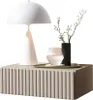 A white table lamp, a black vase with a plant, and a glass of water are placed on a ribbed gray nightstand. Produktbild-Vorschau