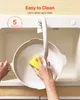 A person is cleaning a pot in a sink with a sponge. Podgląd zdjęcia produktu
