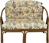 A close-up shot of a floral-patterned cushion on a rattan bench. Produktbild-Vorschau