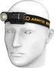 A white mannequin head wearing a black headlamp with yellow branding. Produktbild-Vorschau