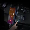 A hand is shown pressing a button on a car FM transmitter while a smartphone is connected and displaying an incoming call. Anteprima dell’immagine prodotto