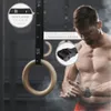 A muscular man is shown preparing for a workout with gymnastic rings. Produktbild-Vorschau