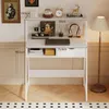 A white computer desk with shelves and a drawer, decorated with various items. Produktbild-Vorschau