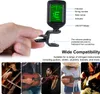 A hand holding a digital tuner, with text and images of various musical instruments. Náhled obrázku produktu