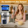 A woman is holding a hand blender in a kitchen setting, with a bowl of food and product information displayed. Produktbild-Vorschau