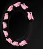 A circular arrangement of pink hula hoop segments on a black background. Podgląd zdjęcia produktu