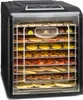 A food dehydrator with multiple trays filled with various dried fruits and vegetables. Náhľad obrázku produktu