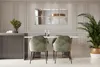 A modern dining room with a table and chairs, decorated with mirrors and a plant. Produktbild-Vorschau