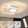 A modern, white LED ceiling light with a unique geometric design, mounted on a ceiling. The image also shows three smaller inset images demonstrating different light color temperatures and a remote control. Produktbild-Vorschau