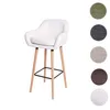 A white bar stool with wooden legs against a white background, with swatches of different fabric colors on the right. Náhled obrázku produktu
