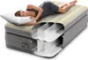 A woman is sleeping on an inflatable mattress, with a cutaway view showing the internal structure. Produktbild-Vorschau